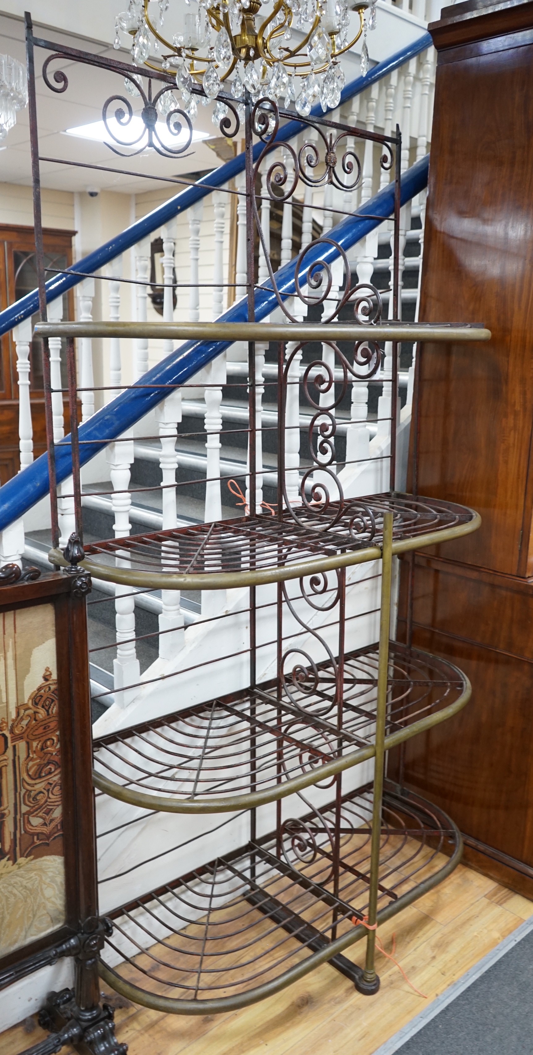 A 19th century French wrought iron and brass bakers rack, width 115cm, depth 46cm, height 215cm